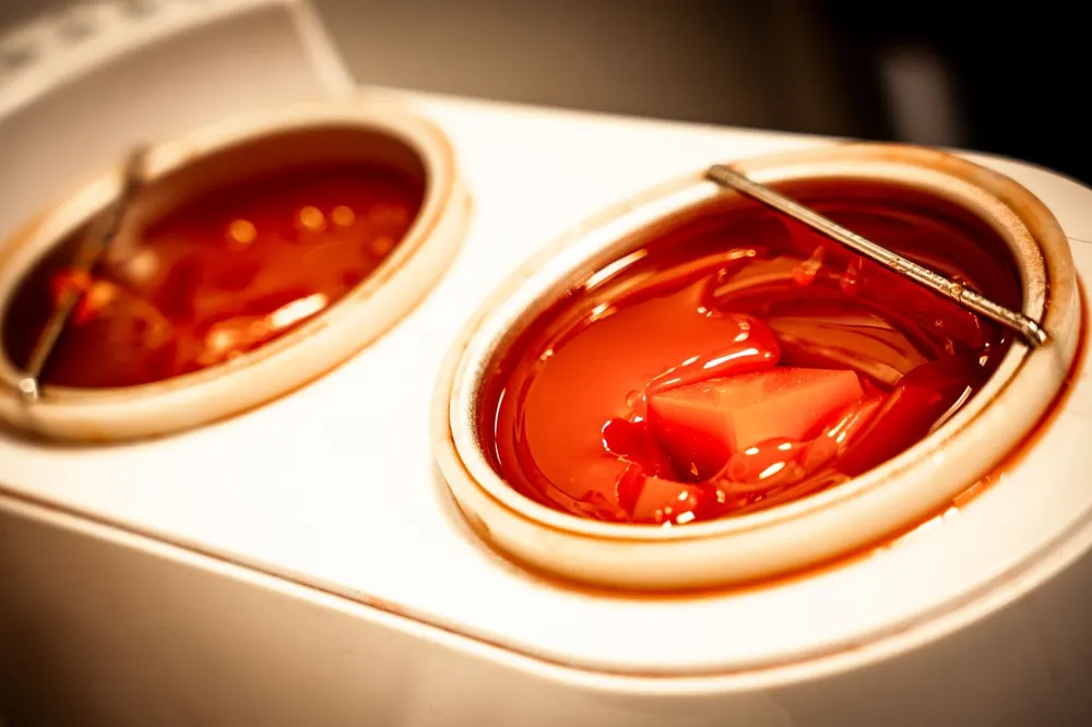 Hot wax warming in the pots before an intimate waxing treatment at Skin and Beauty Box Bristol