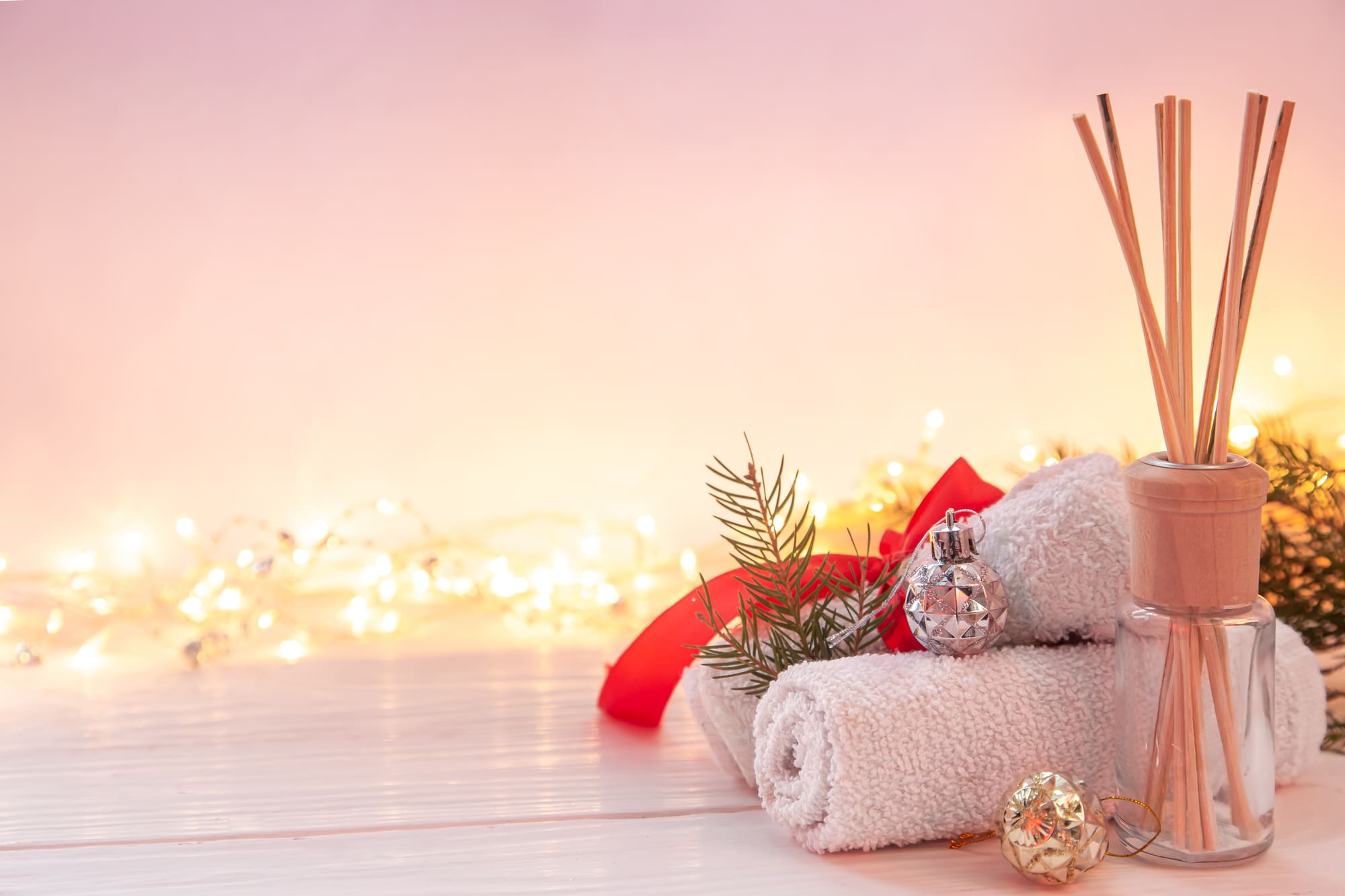 Rolled spa towels, a red ribbon, pine sprigs and glowing fairy lights: Christmas gifts from Skin & Beauty Box, Bristol